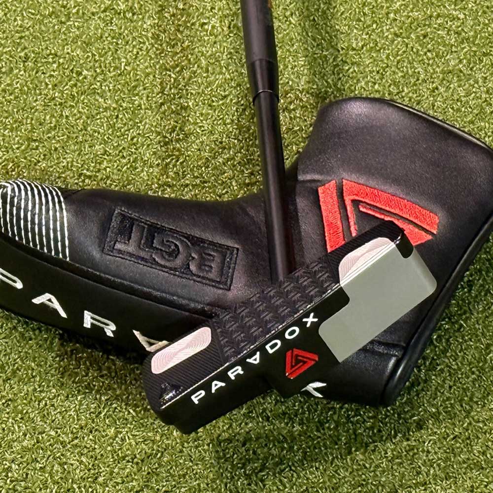 Golf putter with 'Paradox X' head on a green grass background