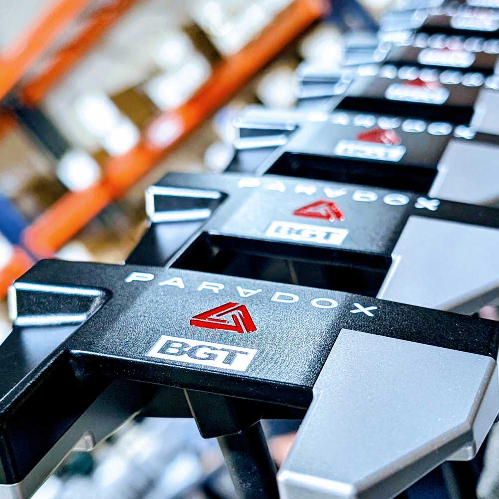 Close-up of BGT Paradox Mallet Putter with blurred warehouse background