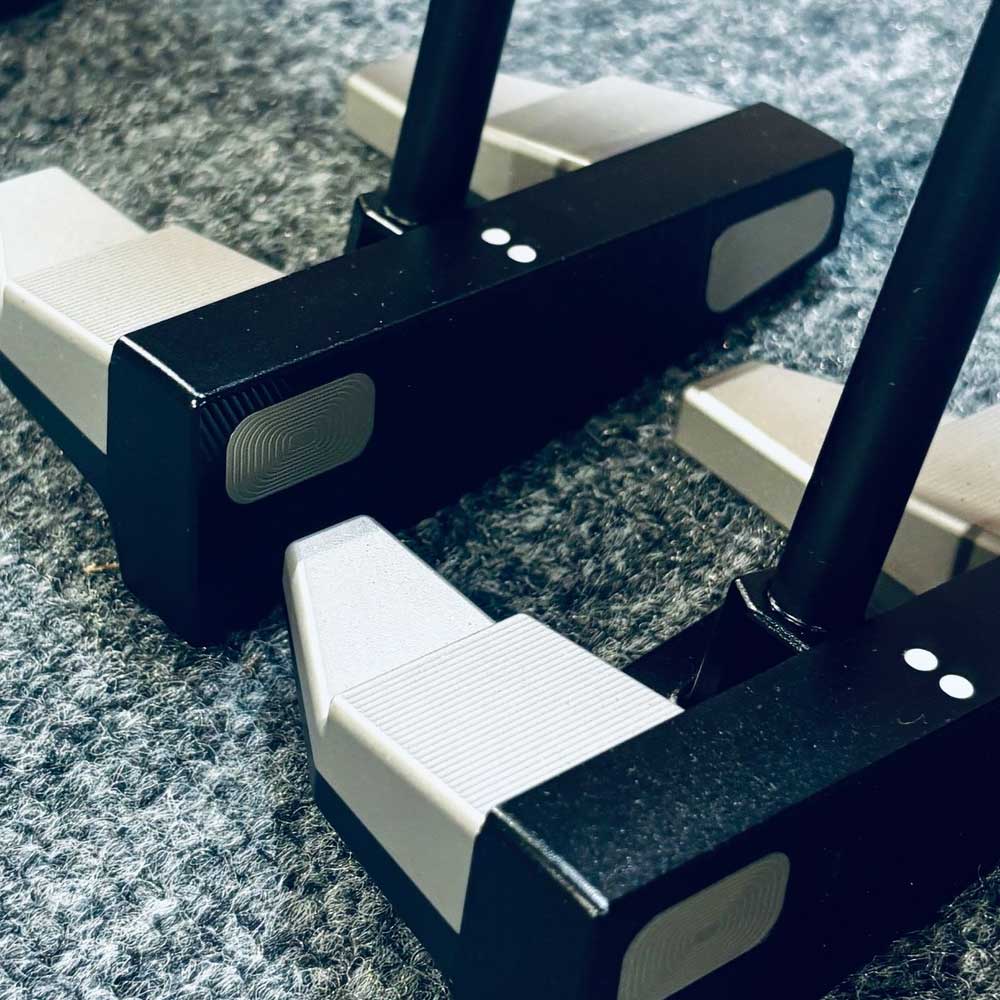 Two BGT Paradox Mallet Putter with black and white design on a textured surface