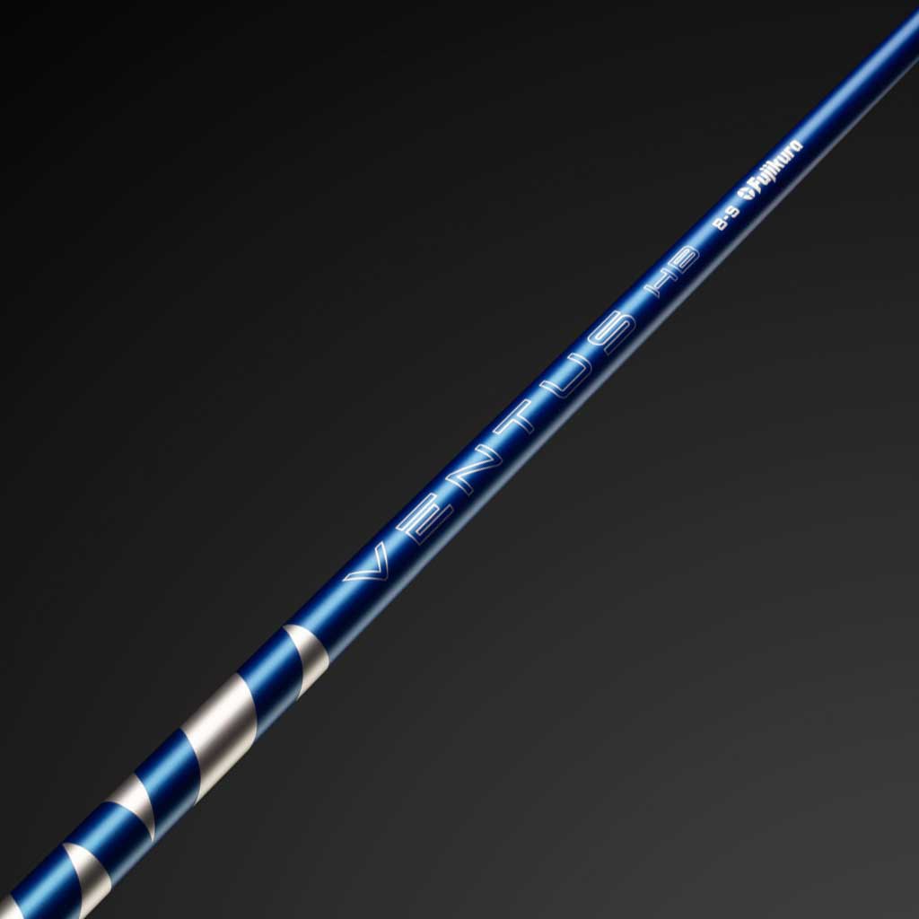 Blue and silver golf club shaft on a dark background