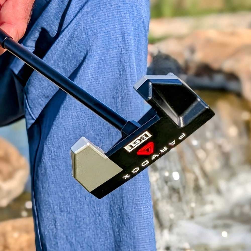 BGT Paradox Mallet Putter with 'Paradox' branding held by a person wearing a blue jacket, blurred natural background