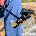 BGT Paradox Mallet Putter with 'Paradox' branding held by a person wearing a blue jacket, blurred natural background
